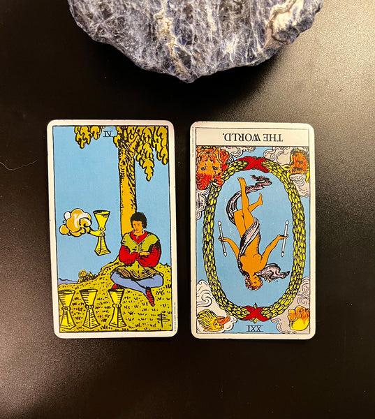 Tarot Musings: December 19, 2022 -- Four of Cups and The World, Reversed